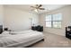 Comfortable bedroom with a ceiling fan and large window, offering a bright and airy space for rest and relaxation at 9285 Swimming Dr, Harrisburg, NC 28075