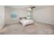 Bright bedroom with carpet, ample natural light, and neutral decor creates a serene and inviting atmosphere at 9285 Swimming Dr, Harrisburg, NC 28075