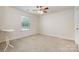 Bedroom featuring carpet, a ceiling fan, and abundant natural light, providing a cozy and comfortable atmosphere at 9285 Swimming Dr, Harrisburg, NC 28075
