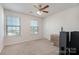 Bright bedroom with carpet, ceiling fan, and plenty of natural light from two windows, creating a comfortable space at 9285 Swimming Dr, Harrisburg, NC 28075