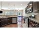 Well-equipped kitchen with stainless steel appliances, granite counters, and an open layout connecting to the dining area at 9285 Swimming Dr, Harrisburg, NC 28075