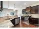Well-appointed kitchen featuring granite countertops, stainless steel appliances, and dark wood cabinetry at 9285 Swimming Dr, Harrisburg, NC 28075