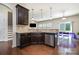 Open-concept kitchen with stainless steel appliances, granite countertops, and a view of the adjacent dining area at 9285 Swimming Dr, Harrisburg, NC 28075