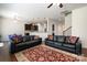Spacious living room featuring hardwood floors, plush sofas, and an open layout leading to the kitchen at 9285 Swimming Dr, Harrisburg, NC 28075