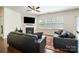 Comfortable living room with a fireplace, large windows, and hardwood flooring, ideal for Gathering gatherings at 9285 Swimming Dr, Harrisburg, NC 28075