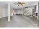 Large finished basement featuring drop ceiling, white support pillars, and carpeted floors at 9928 Raddington Ln, Charlotte, NC 28269