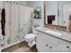 Bathroom featuring a modern vanity, decorative shower curtain, and a framed mirror at 9928 Raddington Ln, Charlotte, NC 28269