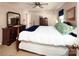 Comfortable bedroom with a four-poster bed, dark wood dressers, and plenty of natural light at 9928 Raddington Ln, Charlotte, NC 28269