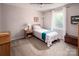 This is a cozy bedroom with natural light and a comfortable single bed at 9928 Raddington Ln, Charlotte, NC 28269