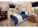 Charming bedroom featuring a queen bed, wooden accents, and natural light at 9928 Raddington Ln, Charlotte, NC 28269