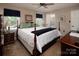 Comfortable bedroom with a four-poster bed, dark wood furniture, and plenty of natural light at 9928 Raddington Ln, Charlotte, NC 28269