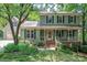Charming two-story home featuring an inviting front porch and a well-manicured lawn at 9928 Raddington Ln, Charlotte, NC 28269