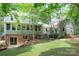 Expansive backyard view of the multi-story home with walkout basement and mature landscaping at 9928 Raddington Ln, Charlotte, NC 28269