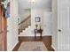 Inviting foyer featuring hardwood floors, a staircase, and a charming accent table at 9928 Raddington Ln, Charlotte, NC 28269