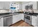 Kitchen featuring stainless steel appliances, white cabinets, and wood floors at 9928 Raddington Ln, Charlotte, NC 28269