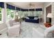 Sunroom with an abundance of natural light, cozy seating, and a ceiling fan at 9928 Raddington Ln, Charlotte, NC 28269