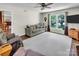 Cozy living room featuring a ceiling fan, a comfortable sofa, and a large window at 9928 Raddington Ln, Charlotte, NC 28269