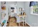 Bright room with a small desk and chair, natural light, and a laundry area at 9928 Raddington Ln, Charlotte, NC 28269