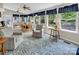 Bright sun room with lots of windows, casual seating, and a dining table, perfect for relaxing or entertaining at 9928 Raddington Ln, Charlotte, NC 28269