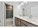 Bright bathroom featuring double vanity sinks, decorative fixtures and a shower with tile surround at 10022 Wayfair Meadow Ct, Charlotte, NC 28277