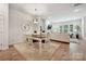 Cozy dining area featuring hardwood floors, a modern chandelier, and seamless access to the living room at 10022 Wayfair Meadow Ct, Charlotte, NC 28277