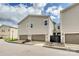 Modern townhouse exterior featuring a two-car garage, neutral siding, and well-maintained landscaping at 10022 Wayfair Meadow Ct, Charlotte, NC 28277