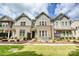 Charming townhome with a mix of brick and siding, a small front yard with seating, and a welcoming entrance at 10022 Wayfair Meadow Ct, Charlotte, NC 28277