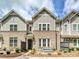 Charming brick townhome with a cozy front patio seating area and well-manicured landscaping at 10022 Wayfair Meadow Ct, Charlotte, NC 28277