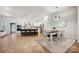 Stylish kitchen featuring white cabinets, stainless steel appliances, a large island, and an adjacent dining area at 10022 Wayfair Meadow Ct, Charlotte, NC 28277