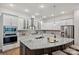 Modern kitchen with a large island, granite countertops, stainless steel appliances, and white cabinetry at 10022 Wayfair Meadow Ct, Charlotte, NC 28277