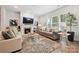 Inviting living room features a fireplace, hardwood floors, and large windows for natural light at 10022 Wayfair Meadow Ct, Charlotte, NC 28277