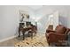 Well lit office with a desk, leather armchair, and attached bathroom at 10022 Wayfair Meadow Ct, Charlotte, NC 28277