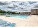 Outdoor pool area with a large pool, blue umbrellas, and plenty of lounge chairs at 10022 Wayfair Meadow Ct, Charlotte, NC 28277