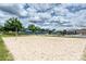Sand volleyball court with clear skies, umbrellas, and distant recreational facilities at 10022 Wayfair Meadow Ct, Charlotte, NC 28277