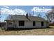 Rear view of the home displaying well-maintained siding and a chimney at 1012 4Th St, Statesville, NC 28677