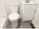 Neat bathroom featuring a white toilet, a vanity with sink and laminate flooring at 1012 4Th St, Statesville, NC 28677