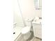 Neat bathroom featuring a white toilet, shower, vanity with sink and laminate flooring at 1012 4Th St, Statesville, NC 28677