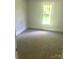 Bedroom with neutral carpet, white trim and a window providing natural light at 1012 4Th St, Statesville, NC 28677