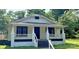Charming single-story home with a covered porch, white pillars, and stairs leading to the front door at 1012 4Th St, Statesville, NC 28677