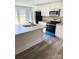 Well-lit kitchen with white cabinets, stainless steel appliances, a kitchen island, and modern flooring at 1012 4Th St, Statesville, NC 28677