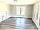 Bright living room featuring a decorative fireplace, large windows, and laminate flooring at 1012 4Th St, Statesville, NC 28677