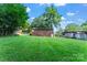 Spacious backyard with lush green grass and mature trees creating shade at 106 Valley Rd, York, SC 29745