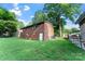 Brick home featuring a spacious backyard with lawn and mature tree at 106 Valley Rd, York, SC 29745