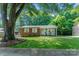 Charming brick home featuring a manicured lawn and covered porch with seating at 106 Valley Rd, York, SC 29745