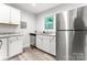 Well-lit kitchen features stainless steel appliances and white cabinets with granite countertops at 106 Valley Rd, York, SC 29745