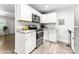 Bright kitchen features stainless steel appliances and white cabinets with granite countertops at 106 Valley Rd, York, SC 29745