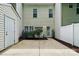 Enclosed backyard with a concrete patio, small garden, and white privacy fence, perfect for outdoor entertaining at 10867 Garden Oaks Ln, Charlotte, NC 28273