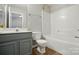 Well-lit bathroom showcases a modern vanity and a combined shower and bathtub at 10867 Garden Oaks Ln, Charlotte, NC 28273