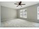 Neutral bedroom with light carpet and a ceiling fan, offering a serene and comfortable space at 10867 Garden Oaks Ln, Charlotte, NC 28273