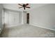 This bedroom features double closets with doors, carpet, neutral walls, and natural light at 10867 Garden Oaks Ln, Charlotte, NC 28273